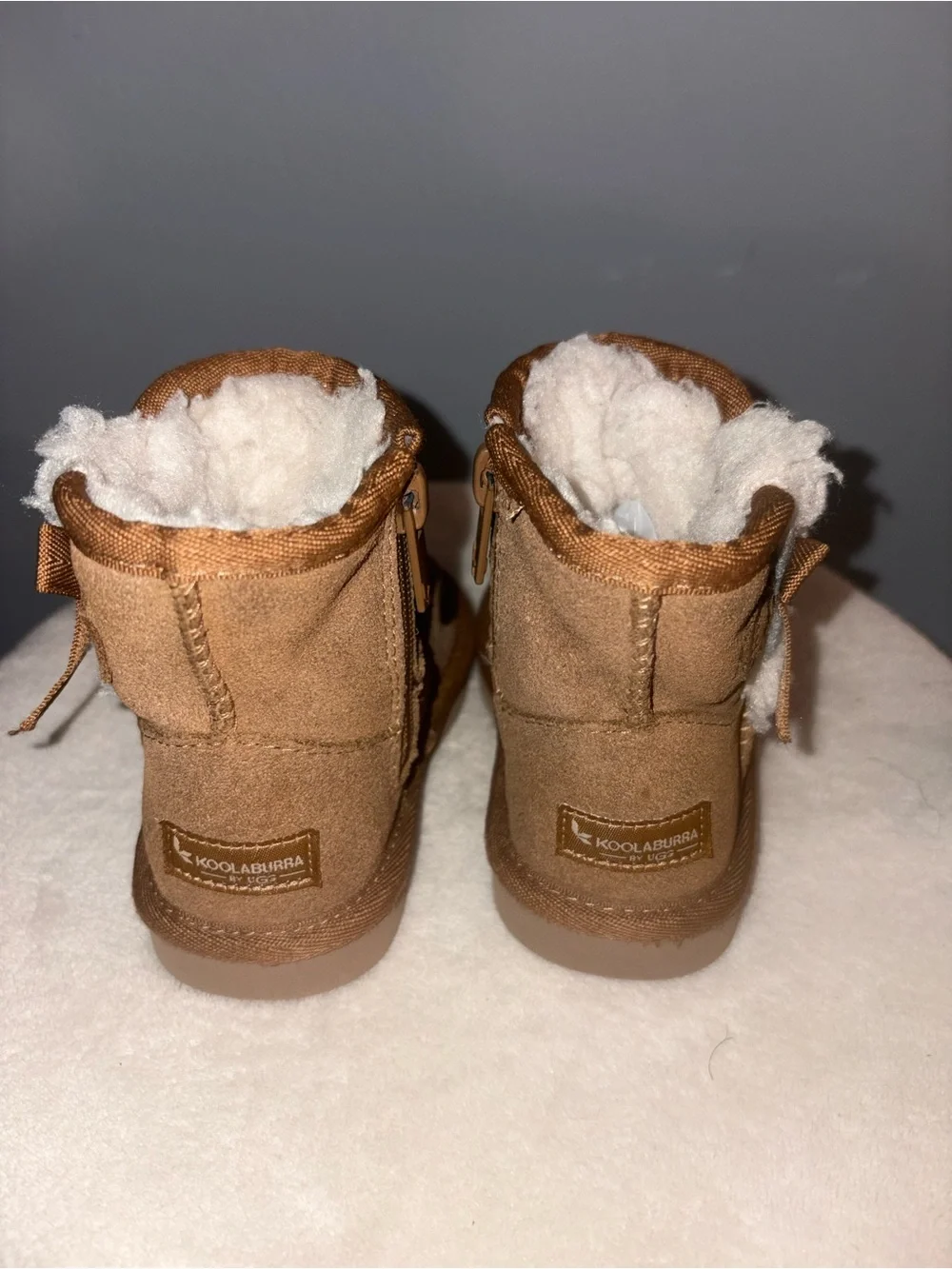 Pair of Cozy Suede toddler boots in Chestnut kookaburra by Ugg and Black sued